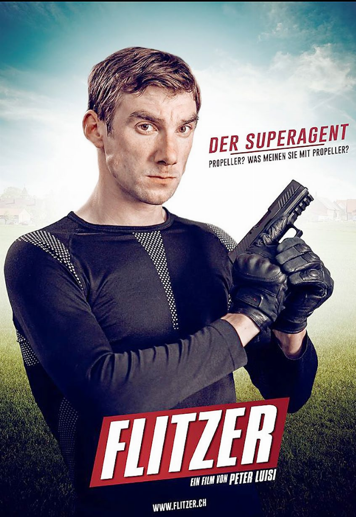 Plakat im Bond-Stil: Aaron Hitz in der erfolgreichen Kinokomödie «Flitzer» von Peter Luisi mit Beat Schlatter. Foto: SRF Plakat im Bond-Stil: Aaron Hitz in der erfolgreichen Kinokomödie «Flitzer» von Peter Luisi mit Beat Schlatter. Foto: SRF